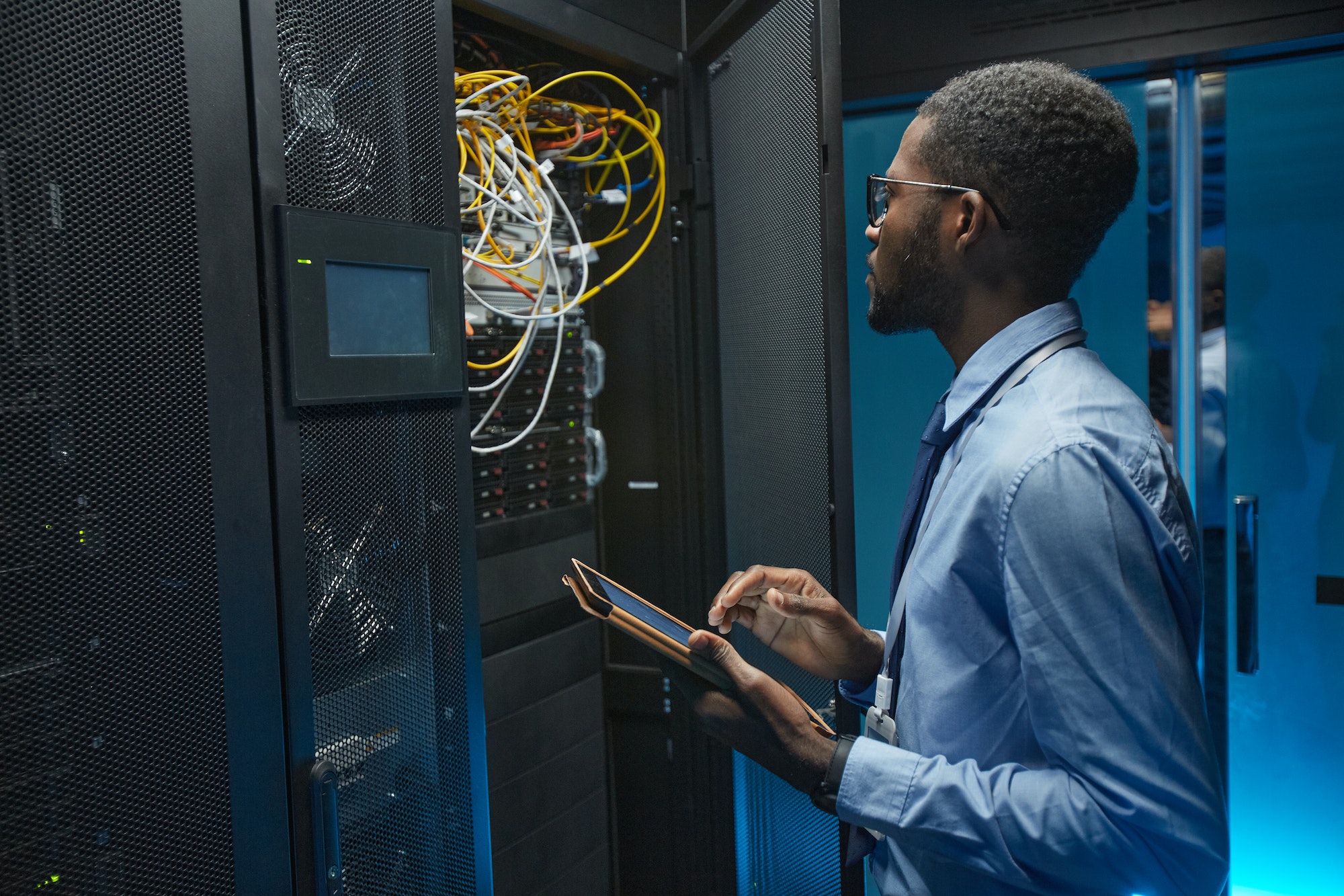 African American Data Engineer in Server Room